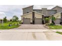 Modern two-story townhome with two-car garage and attractive exterior finishes at 9355 Sommerset Hills Dr # 9355, Davenport, FL 33896