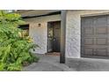 Newly remodeled front entrance with a dark brown door and stone facade at 3722 Paige St, Port Orange, FL 32129