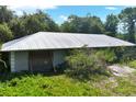 Ranch-style home with metal roof, needing repairs at 2795 Absher Rd, Saint Cloud, FL 34771