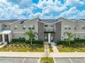 Modern townhouses with gray siding and landscaping at 4222 Paragraph Dr, Kissimmee, FL 34746