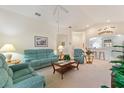 Bright and airy living room with teal reclining furniture at 405 High Vista Dr, Davenport, FL 33837