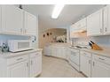 Bright kitchen with white cabinets, microwave, and stove at 405 High Vista Dr, Davenport, FL 33837