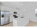 Modern kitchen featuring stainless steel appliances and a large island at 817 Blue Creek Dr, Haines City, FL 33844