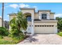 Two-story house with a two-car garage and palm tree at 1556 N Hampton Dr, Davenport, FL 33897