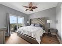 Spacious main bedroom with a king-size bed and water views at 13427 Blue Heron Beach Dr # 1901, Orlando, FL 32821