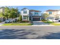 Two-story house with stone accents, a large garage, and landscaping at 9032 Flamingo Key Way, Kissimmee, FL 34747