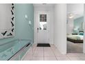 Bright entryway with tile floors, a mirror, and view to a bedroom at 9032 Flamingo Key Way, Kissimmee, FL 34747