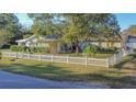 Ranch style home with a white picket fence at 1501 Ne 57Th St, Ocala, FL 34479