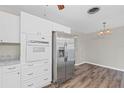 Modern kitchen with white cabinets, stainless steel appliances and granite countertops at 3210 Carleton W Cir, Lakeland, FL 33803