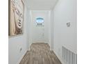 Bright entryway with grey tile floors and white walls at 6282 Lakepine St, St Cloud, FL 34771