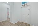 Light entryway with grey tile floors and white door at 6282 Lakepine St, St Cloud, FL 34771