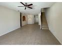 Living room with tile floor and staircase at 4980 W Castle W St, Kissimmee, FL 34758