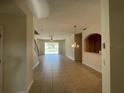 Spacious living room with tile floors and view to backyard at 4980 W Castle W St, Kissimmee, FL 34758