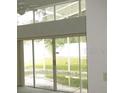 Living room with sliding glass doors opening to a view of the pool at 216 Balmoral Ct, Davenport, FL 33896