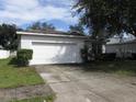 House exterior featuring a white single-car garage and well-maintained lawn at 216 Balmoral Ct, Davenport, FL 33896