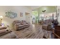 Living room featuring hardwood floors and ample seating at 117 Ridge View Dr, Davenport, FL 33837