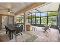 Spacious sunroom with a view, comfortable seating, and a dining area at 203 Escondido Ct, Poinciana, FL 34759