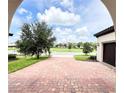 Brick driveway with view of neighborhood at 10091 Austrina Oak Loop, Winter Garden, FL 34787