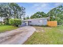 Newly renovated home with gray exterior and driveway at 1318 Terre Cia Ave, Orlando, FL 32807