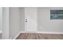 Front entry with white door and wood-look floors at 1318 Terre Cia Ave, Orlando, FL 32807