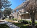 Side view of two story tan house with gray roof and landscaping at 3433 Soho St # 202, Orlando, FL 32835