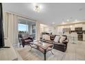 Spacious living room with a leather sofa and large windows at 4721 Clock Tower Dr # 302, Kissimmee, FL 34746