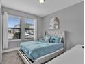 Spacious bedroom with large windows and plush bedding at 4716 Terra Esmeralda Dr, Kissimmee, FL 34746