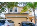 Two-story house with a two-car garage at 338 Earlmont Pl, Davenport, FL 33896