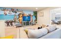 Gathering-friendly game room with a large TV and fun decor at 9047 Rhodes St, Kissimmee, FL 34747