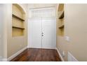 Bright entryway with double doors and built-in shelves at 3222 Stonehurst Cir, Kissimmee, FL 34741