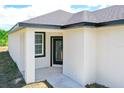 New construction home with a black front door at 48 Atlantic Ave, Babson Park, FL 33827