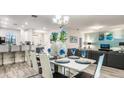 Bright dining room with modern table and seating for six at 1495 Rolling Fairways Dr, Davenport, FL 33896