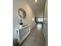 Bright and airy entryway with tile flooring and a console table at 718 Longboat Dr, Davenport, FL 33896