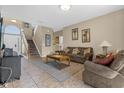 Spacious living room with tiled floors and comfy sofas at 476 Calabay Parc Blvd, Davenport, FL 33897