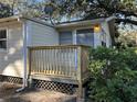 House exterior showcasing a newly built wooden deck and surrounding landscape at 6790 Bass Hwy, St Cloud, FL 34771