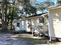 Side view of a house with a wooden deck and surrounding landscape at 6790 Bass Hwy, St Cloud, FL 34771