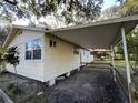 House exterior with carport and surrounding trees at 6790 Bass Hwy, Saint Cloud, FL 34771