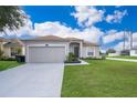 One-story house with gray siding, attached garage, and well-manicured lawn at 905 Knollwood Dr, Davenport, FL 33837
