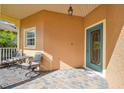 Quaint front porch with seating area, inviting entryway at 227 Verona Dr, Poinciana, FL 34759