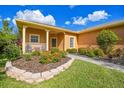 Well-maintained landscaping, inviting walkway to a charming house at 227 Verona Dr, Poinciana, FL 34759