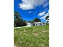 Newly built home with gray siding and a large yard at 1339 Tallahassee Ct, Kissimmee, FL 34759