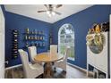 Charming dining area with a round table and four chairs, built-in wine rack at 2771 Cedaridge Cir, Clermont, FL 34711