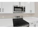 Stainless steel range and microwave in a modern kitchen at 4216 Sawtooth Ct, Tavares, FL 32778