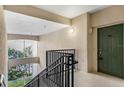 Interior stairwell leading to condo unit with green door at 3301 Whitestone Cir # 308, Kissimmee, FL 34741