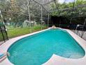 Inviting kidney-shaped pool with a screened enclosure at 2556 Bear Creek Ct, Kissimmee, FL 34747