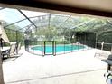 Relaxing screened pool area with waterfall feature and lounge chairs at 2556 Bear Creek Ct, Kissimmee, FL 34747
