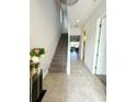 Bright and airy entryway with tiled floors and staircase at 166 Captiva Dr, Davenport, FL 33896
