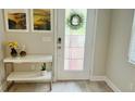 Bright entryway with white console table, artwork, and wreath on door at 13706 Werrington Dr, Winter Garden, FL 34787