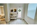 Light and airy entryway with console table, artwork, and view to bedroom at 13706 Werrington Dr, Winter Garden, FL 34787