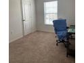 Bright bedroom with carpeted floors and large window at 1523 Wynford Cir, Tavares, FL 32778